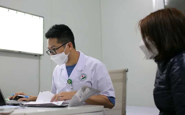 Bác sĩ khám cho bệnh nhân sau khi nhiễm Covid-19.
