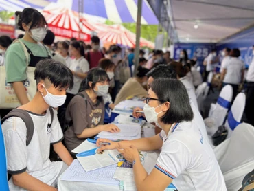 Học sinh đến tìm hiểu thông tin ở gian tư vấn của Trường Đại học Thương mại tại Ngày hội tư vấn tuyển sinh-hướng nghiệp.