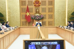 Thủ tướng Phạm Minh Chính và lãnh đạo các bộ, ban, ngành của Chính phủ Việt Nam tham dự Hội nghị cấp cao trực tuyến về biến đổi khí hậu tại điểm cầu Hà Nội. (Ảnh: TRẦN HẢI)