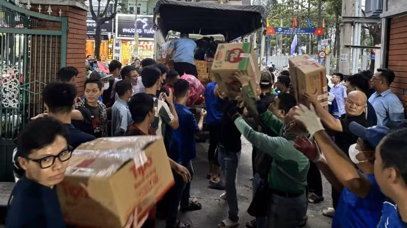 Bốc xếp hàng hóa thiết yếu lên xe để hỗ trợ bà con bị ảnh hưởng bão lũ ở tỉnh Đắk Lắk.