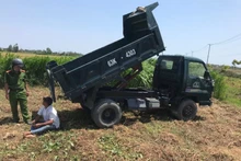 Ông Trần Thanh Triều (ngồi) cùng phương tiện tại hiện trường.