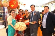 Đại sứ Đinh Ngọc Linh (thứ hai bên phải), Tham tán Lê Phú Cường (ngoài cùng bên phải) và bà Trần Thị Chang, Chủ tịch Hội hữu nghị Malaysia-Việt Nam (thứ hai bên trái) chụp ảnh kỷ niệm tại một quầy hàng giới thiệu ẩm thực Việt. (Ảnh: TTXVN)