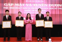 Thứ trưởng Nguyễn Thị Kim Chi trao Bằng khen của Bộ Giáo dục và Đào tạo cho các em học sinh đoạt giải. (Ảnh: PHAN LINH)