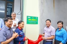 Ông Đồng Xuân Thụ, Tổng biên tập Tạp chí Môi trường và Đô Thị cùng chị Nguyễn Thị Lành mở băng khánh thành ngôi nhà. 
