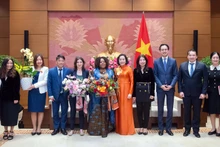Phó Chủ tịch Quốc hội Nguyễn Thị Thanh (thứ 5 từ phải sang) trao hoa tặng bà Caroline Nyamayemombe và bà Michaela Bauer (lần lượt thứ 6 và 7 từ phải sang) cùng đại diện các cơ quan liên quan tại buổi tiếp.