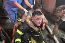 Cảnh sát phòng cháy chữa cháy và cứu nạn cứu hộ đưa người dân thoát khỏi đám cháy.