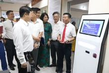 Các đại biểu tham quan mô hình tra cứu thông tin thủ tục và nhận số xếp hàng bằng máy tự động tại phường Mỹ Đình 1.