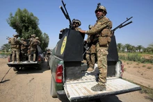 Lực lượng an ninh Iraq tham gia chiến dịch truy quét các tay súng IS tại Tarmiyah, phía bắc thủ đô Baghdad. (Ảnh: AFP/TTXVN)