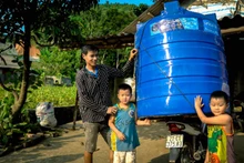 Người dân Yên Bái bị ảnh hưởng bởi bão lũ nhận thùng nước hỗ trợ từ UNICEF. (Ảnh: UNICEF Việt Nam) 