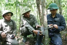 Cán bộ Khu Bảo tồn thiên nhiên Bắc Hướng Hóa đặt bẫy ảnh theo dõi dấu vết gấu ngựa. (Ảnh Khu bảo tồn cung cấp)