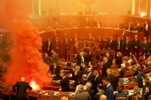 Nghị sĩ đối lập ném bom khói tại phiên họp Quốc hội Albania ở Tirana. (Ảnh REUTERS)