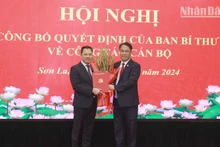 Đồng chí Phan Thăng An, Phó Trưởng Ban Tổ chức Trung ương trao Quyết định và hoa chúc mừng đồng chí Nguyễn Đình Việt.