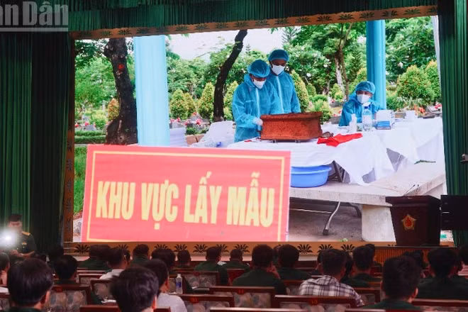 Đại biểu theo dõi thước phim về công tác lấy mẫu hài cốt liệt sĩ. (Ảnh: LÊ THÀNH)