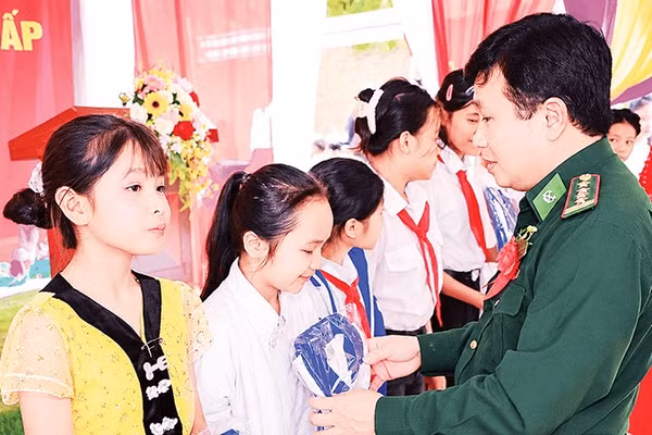 Lãnh đạo Ban Chỉ huy Bộ đội Biên phòng tỉnh Nghệ An trao quà tặng các học sinh vùng biên. 