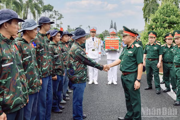 Thượng tướng Lê Quang Minh tặng quà động viên lực lượng thực hiện nhiệm vụ lấy mẫu hài cốt liệt sĩ chưa xác định được thông tin tại Nghĩa trang liệt sĩ Tiền Giang, tỉnh Đồng Tháp. (Ảnh: CHÍ PHÚC)