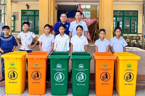 Cán bộ Quỹ Bảo vệ và Phát triển rừng tỉnh Điện Biên trao thùng đựng rác thân thiện môi trường cho Trường THCS Mường Mùn, xã Mường Mùn, tỉnh Điện Biên. (ẢNH: BÍCH HẠNH)
