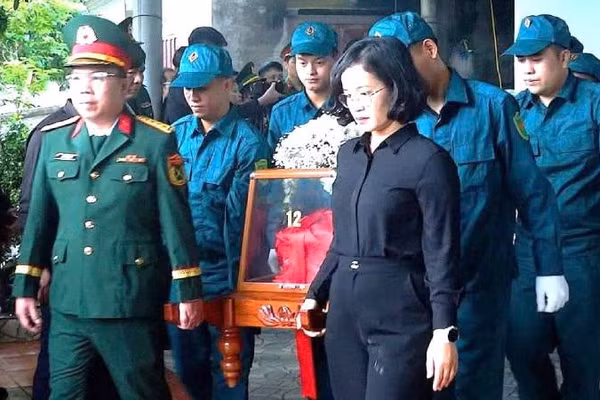 Đại diện lãnh đạo Bộ Chỉ huy Quân sự tỉnh và phường Bắc Gianh di chuyển hài cốt liệt sĩ Nguyễn Quốc Hội về nơi an táng tại Nghĩa trang Quảng Phúc. (Ảnh: NHI ANH) 