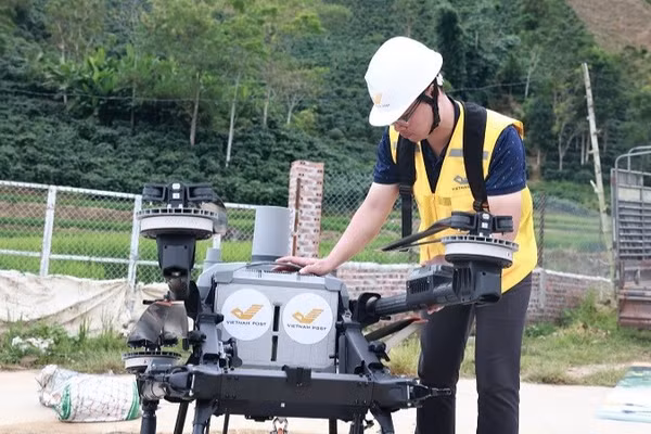 Nhân viên bưu điện thực hiện các thao tác kỹ thuật trước khi điều khiển UAV cất cánh bay thử nghiệm tại xã Mường Ảng. (Ảnh: Bưu điện Việt Nam)