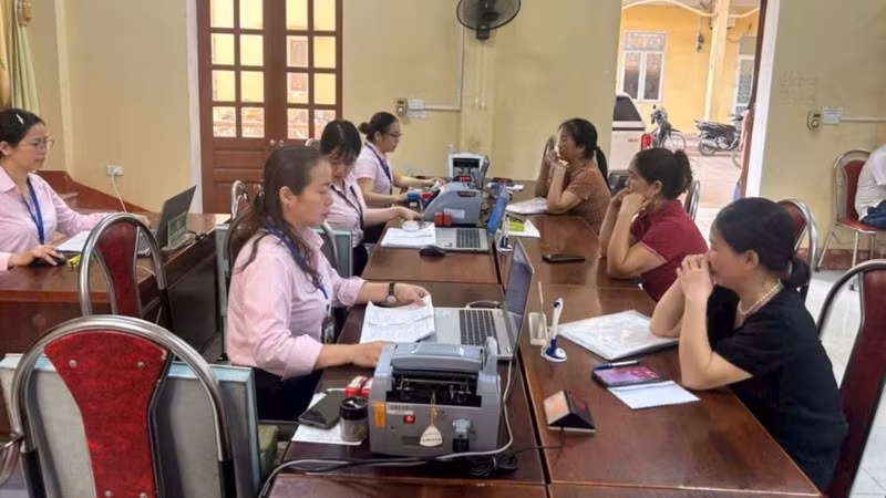 Người dân giao dịch tại điểm giao dịch của Ngân hàng Chính sách xã hội.