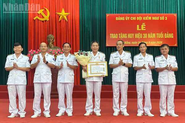 Chụp ảnh lưu niệm với đảng viên được nhận Huy hiệu 30 năm tuổi Đảng. (Ảnh: NGUYỄN DŨNG)