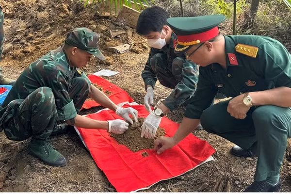 Lực lượng chức năng tiến hành khai quật, cất bốc các hài cốt liệt sĩ. (Ảnh: THANH SƠN)