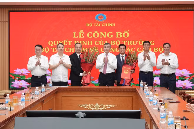 Bộ trưởng Ngô Văn Tuấn trao quyết định, chúc mừng các đồng chí được điều động, bổ nhiệm. (Ảnh: Cổng thông tin điện tử Bộ Tài chính)