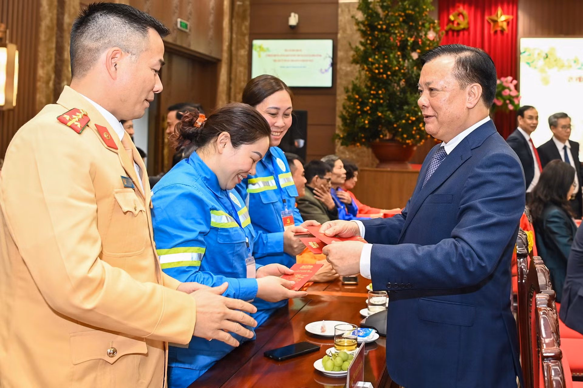 Bí thư Thành ủy Hà Nội Đinh Tiến Dũng mừng tuổi các công nhân, lực lượng vũ trang tại hội nghị. Bí thư Thành ủy Hà Nội Đinh Tiến Dũng mừng tuổi các công nhân, lực lượng vũ trang tại hội nghị.