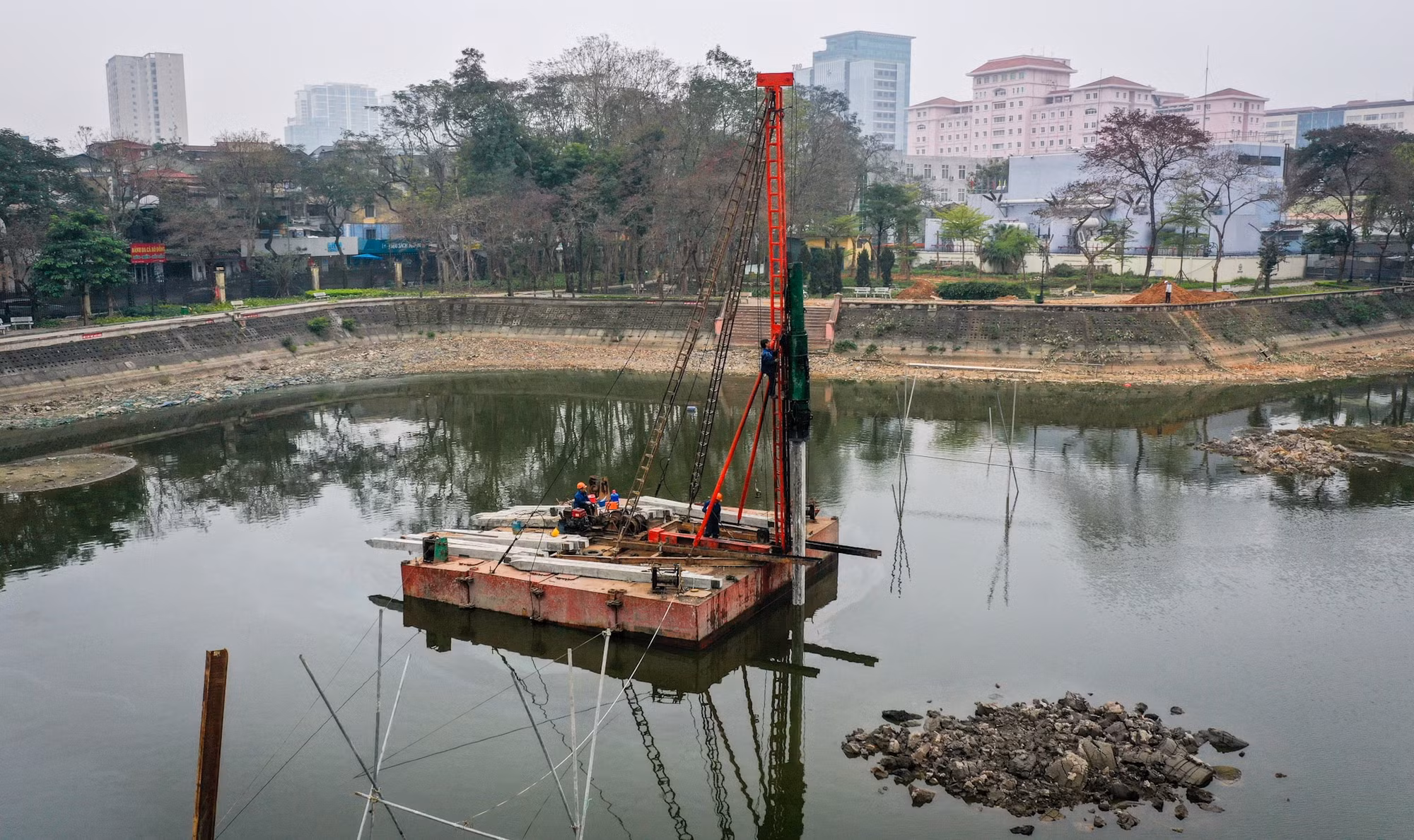 Công nhân làm việc trên lòng hồ Nghĩa Đô. Quá trình này được kỳ vọng sẽ giảm thiểu tình trạng ô nhiễm hiện nay tại khu vực hồ này. Công nhân làm việc trên lòng hồ Nghĩa Đô. Quá trình này được kỳ vọng sẽ giảm thiểu tình trạng ô nhiễm hiện nay tại khu vực hồ này.