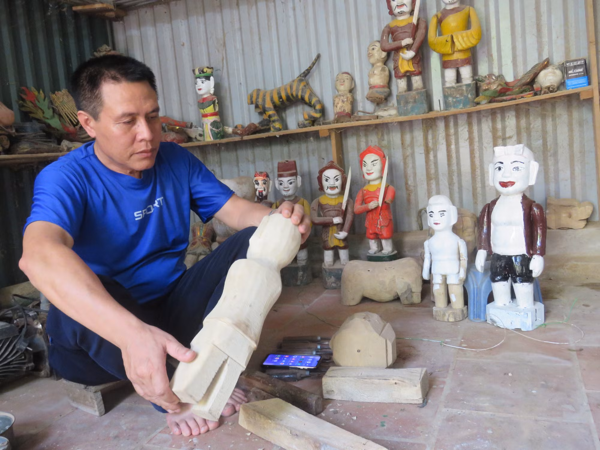 Ông Phi trong xưởng chế tác rối nước của mình. Ông Phi trong xưởng chế tác rối nước của mình.
