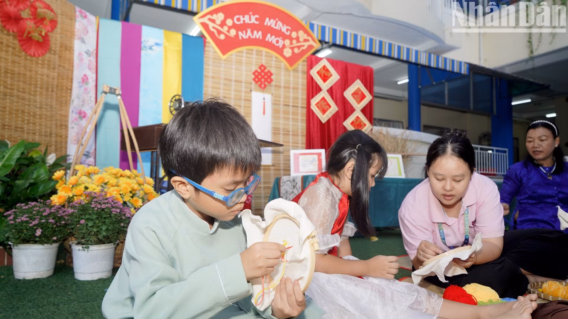 Các bé tham gia trải nghiệm cách thêu hình trên vải.