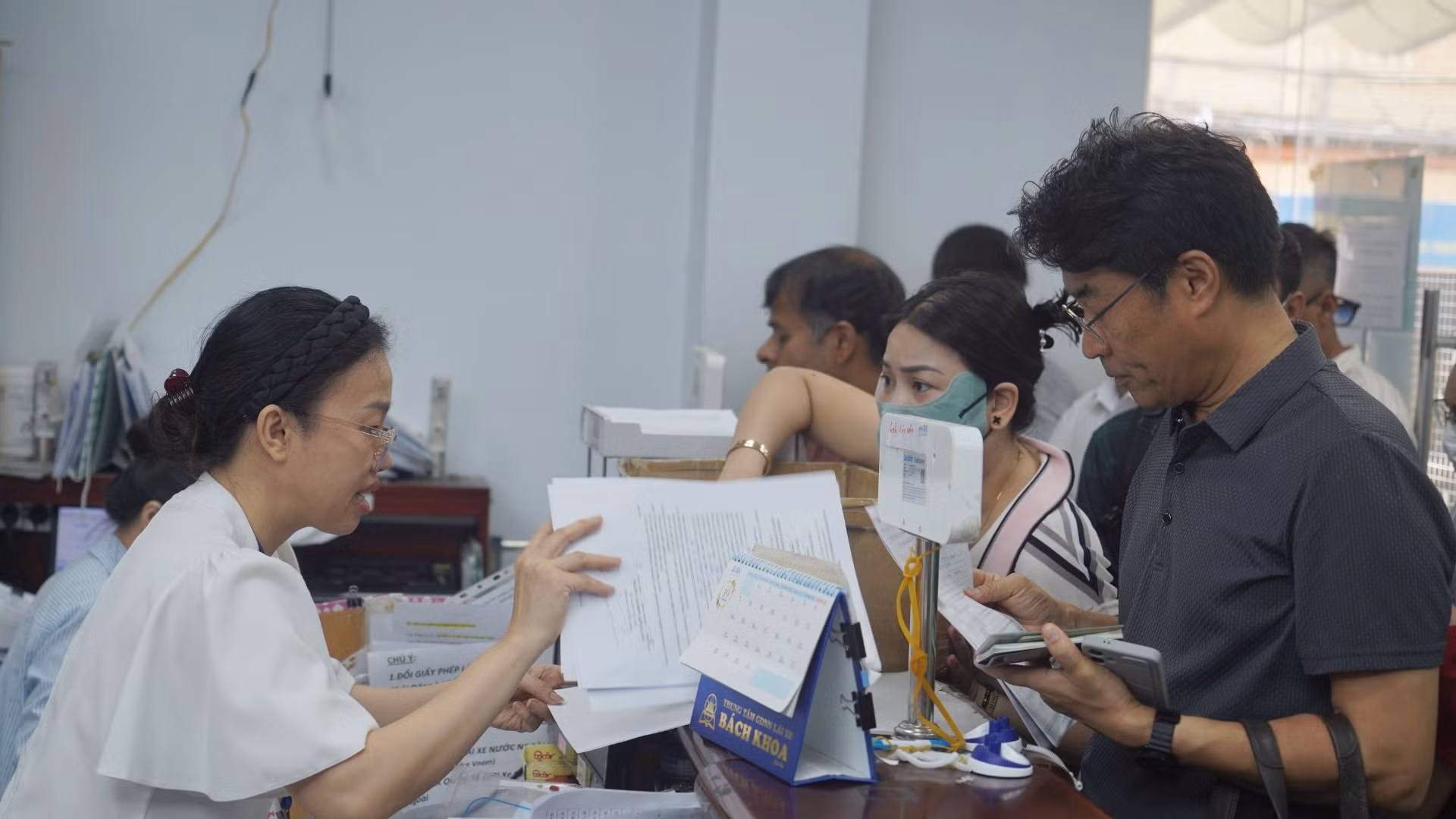 Khu vực nộp hồ sơ đông kín người xếp hàng chờ làm thủ tục.