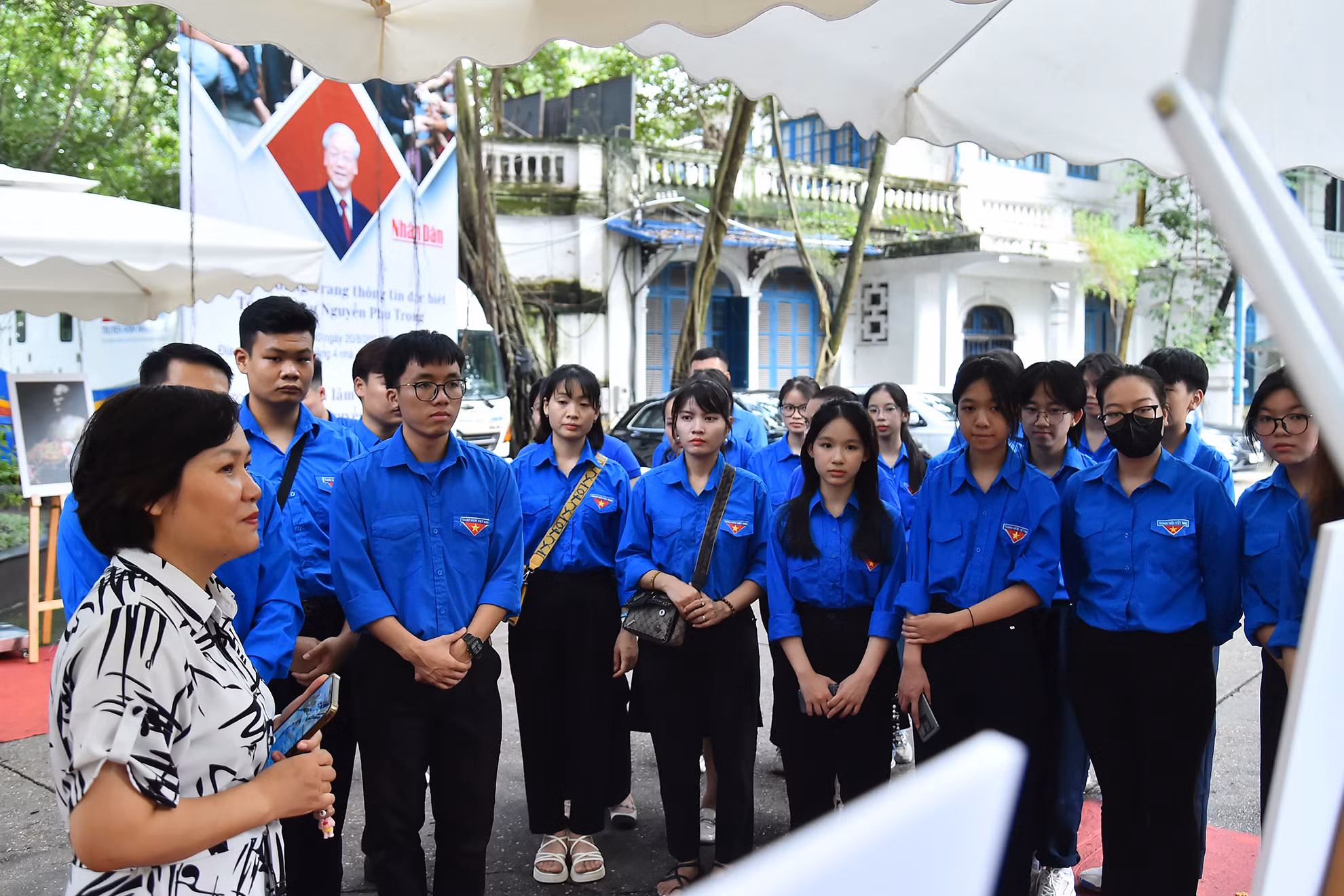 Nhà báo Kiều Thanh Hương, Phó Trưởng Ban Quản lý phóng viên thường trú (Báo Nhân Dân) giới thiệu với các đoàn viên, thanh niên xã Đông Hội về cuộc đời, sự nghiệp của Tổng Bí thư Nguyễn Phú Trọng lúc sinh thời qua các bức ảnh tại triển lãm.