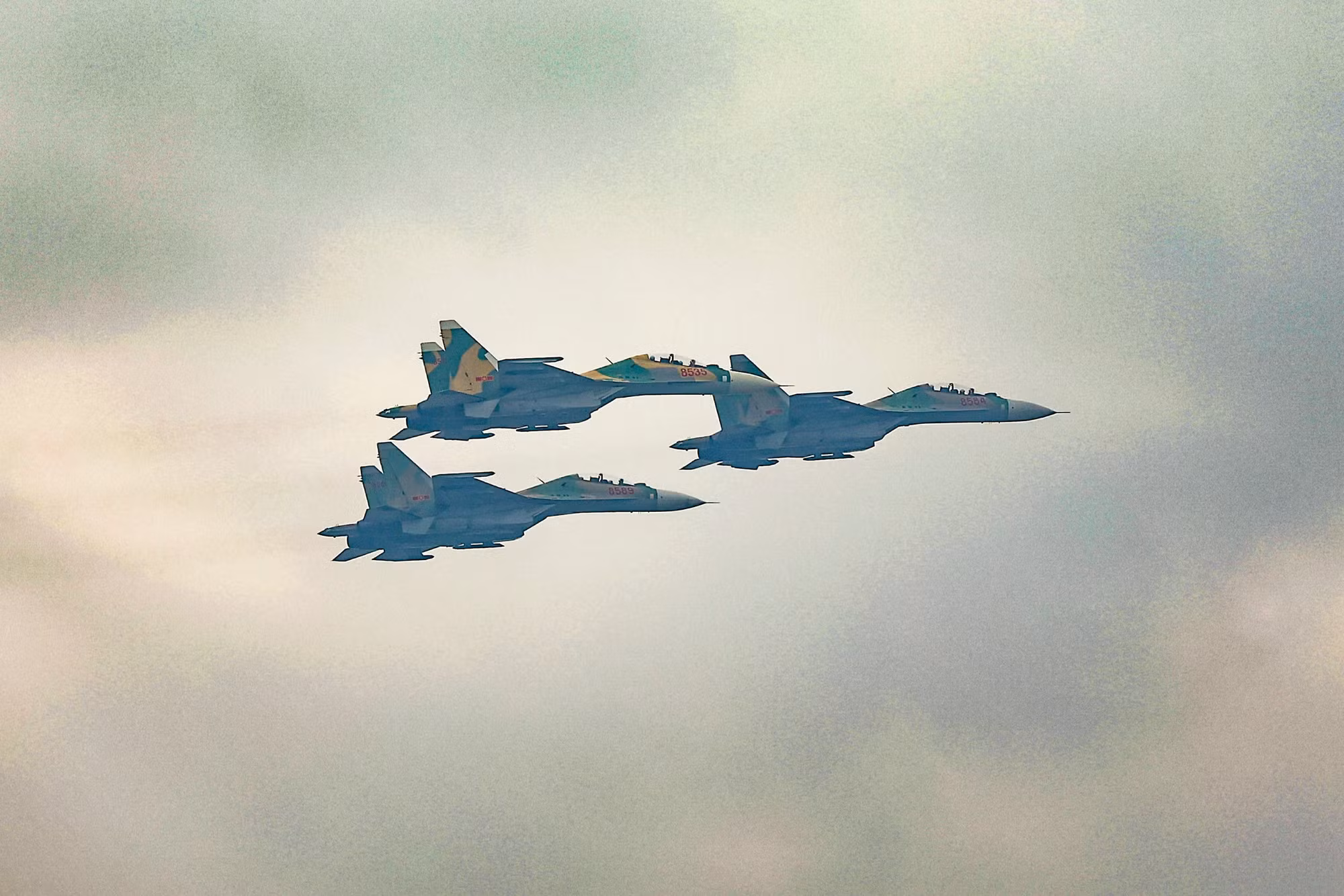 Biên đội Su-30MK2 bay qua lễ đài, cùng lúc nhả đạn mồi bẫy tên lửa trên bầu trời.