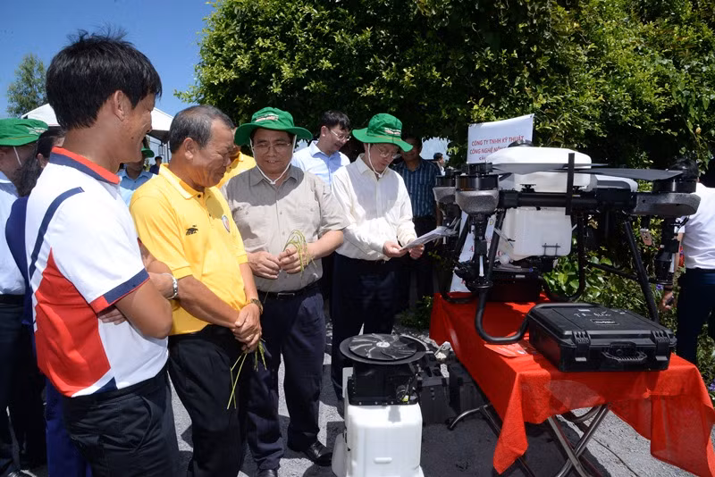 Thủ tướng Phạm Minh Chính nghe giới thiệu về thiết bị bay không người lái phun thuốc trừ sâu tại cánh đồng lúa canh tác theo mô hình công nghệ cao. Thủ tướng Phạm Minh Chính nghe giới thiệu về thiết bị bay không người lái phun thuốc trừ sâu tại cánh đồng lúa canh tác theo mô hình công nghệ cao.