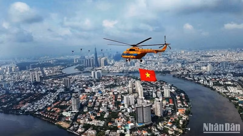 Trực thăng tập luyện bay kéo cờ trên bầu trời thành phố Hồ Chí Minh. (Ảnh: Khiếu Minh)