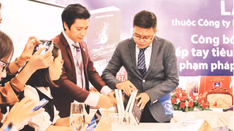Đại diện First News hướng dẫn cách phân biệt sách giả, sách thật tại một cuộc họp báo.
