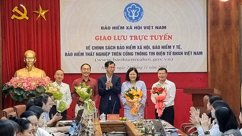 Phó Tổng Giám đốc Bảo hiểm xã hội Việt Nam Đào Việt Ánh tặng hoa khách mời, chuyên gia tham dự giao lưu trực tuyến vào tháng 11/2023. (Ảnh: TÂM TRUNG)