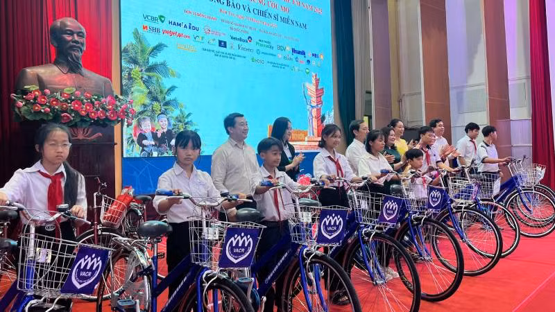 Ban tổ chức tặng xe đạp, quà cho học sinh có hoàn cảnh khó khăn. (Ảnh: HOÀNG TRUNG)