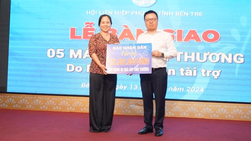Đồng chí Lê Quốc Minh trao bảng tượng trưng hỗ trợ xây dựng 5 căn nhà mái ấm tình thương cho Hội Liên hiệp Phụ nữ tỉnh Bến Tre. (Ảnh: THẾ ANH)
