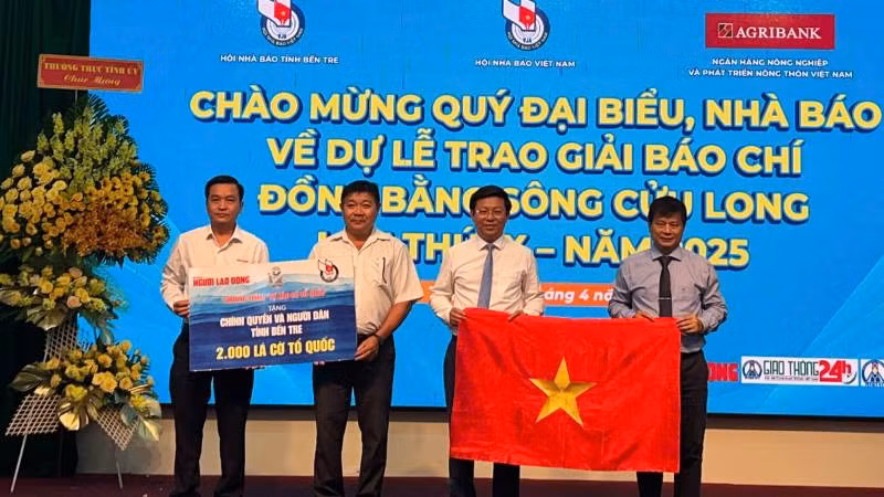 Đại diện Báo Người lao động trao cờ Tổ quốc cho chính quyền và người dân tỉnh Bến Tre. (Ảnh: HOÀNG TRUNG) Đại diện Báo Người lao động trao cờ Tổ quốc cho chính quyền và người dân tỉnh Bến Tre. (Ảnh: HOÀNG TRUNG)