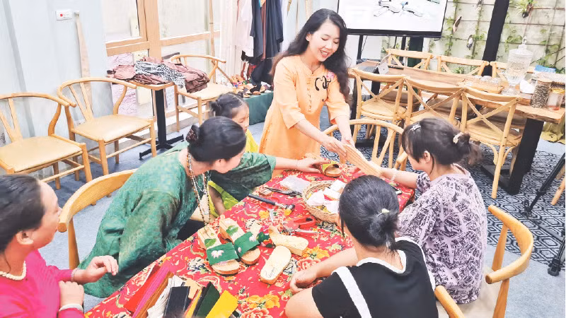 Hướng dẫn khách làm guốc mộc trong một workshop tại Am Cà kê.