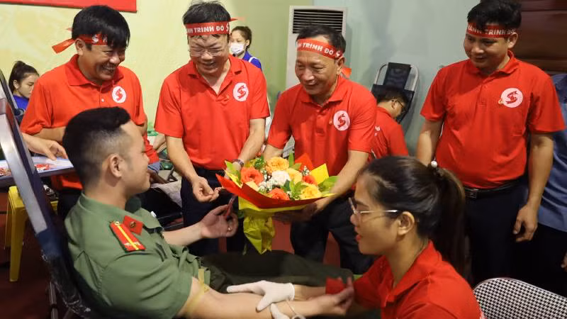 Phó Bí Thư Thường trực Tỉnh ủy Quảng Bình Trần Hải Châu tặng hoa cho tình nguyện viên hiến máu cứu người (Ảnh: DH)