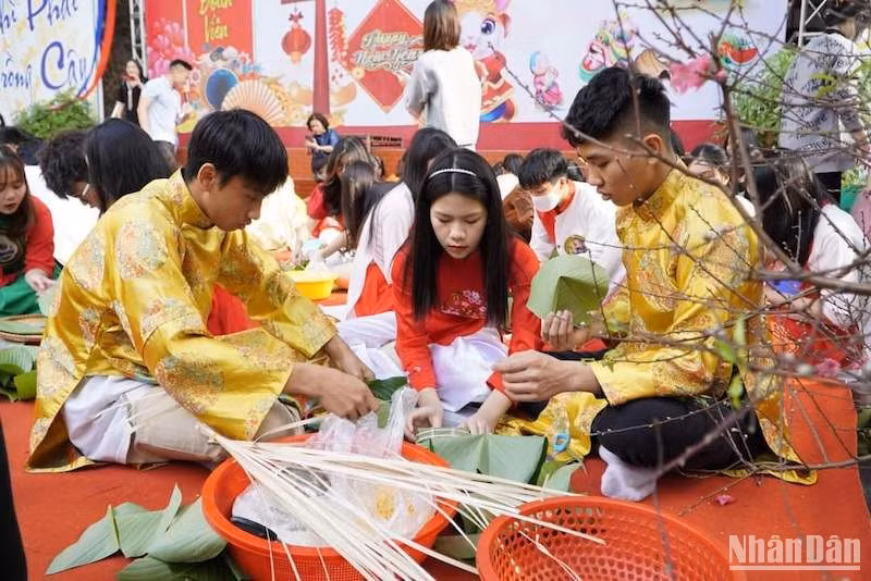 Học sinh cùng nhau gói bánh chưng trong lễ hội Xuân ở trường học