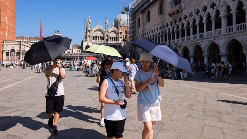 Khách du lịch đi bộ trong đợt nắng nóng đỉnh điểm ở Venice, Italia ngày 22/8/2023. (Ảnh: REUTERS)
