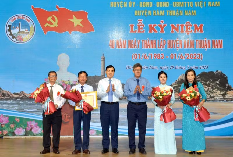 Đại diện lãnh đạo tỉnh Bình Thuận trao Bằng khen của Chủ tịch Ủy ban nhân dân tỉnh và tặng hoa chúc mừng cán bộ, nhân dân huyện Hàm Thuận Nam.