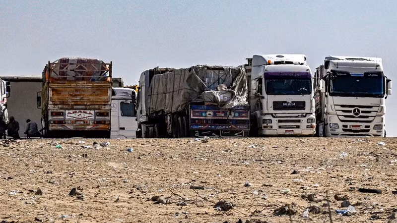 Xe tải chở hàng viện trợ cho Dải Gaza tập trung gần cửa khẩu Rafah bên phía Ai Cập, ngày 23/3. (Ảnh: AFP/TTXVN)