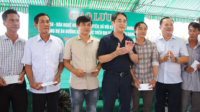 Bí thư Tỉnh ủy Hậu Giang (đứng giữa) trao quà tặng các hộ dân có cao tốc đi qua.