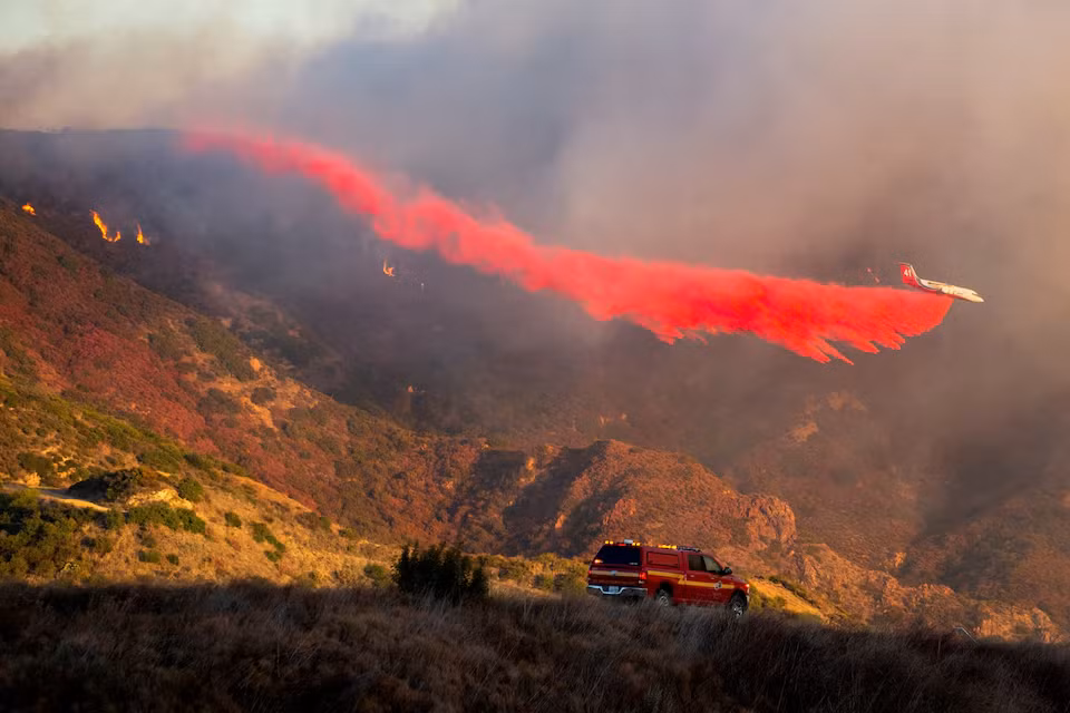 Máy bay cứu hỏa thả chất chống cháy khi Đám cháy Franklin bùng phát ở Malibu, California, Mỹ. Ảnh: Reuters