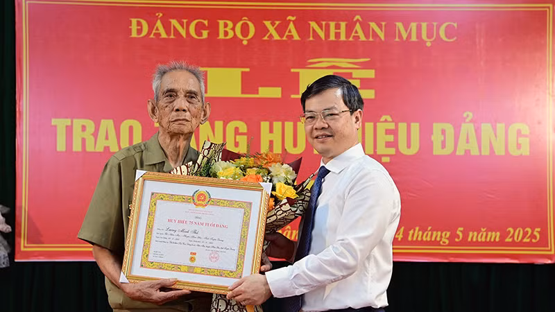 Đồng chí Nguyễn Văn Sơn, Phó Bí thư Tỉnh ủy, Chủ tịch Ủy ban nhân dân tỉnh Tuyên Quang trao Huy hiệu 75 tuổi Đảng cho đảng viên Lương Minh Thủ, chi bộ thôn Kai Con, Đảng bộ xã Nhân Mục, huyện Hàm Yên.