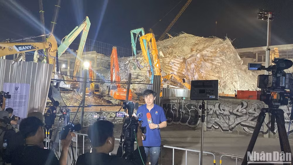 Phóng viên tác nghiệp tại hiện trường sập tòa nhà 30 tầng. (Ảnh: XUÂN SƠN)